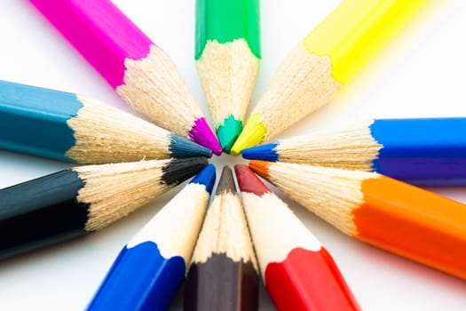 close up of many colorful pencils arranged in circle