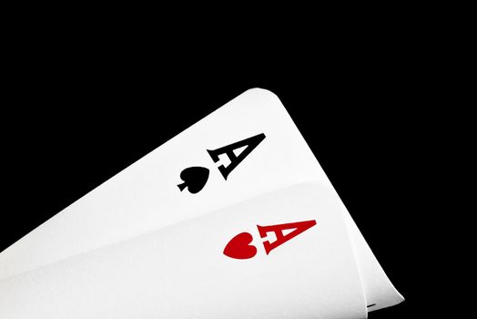 detail of a pair of winning aces  on black background