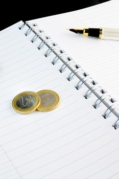 detail of euro coin business on notepad