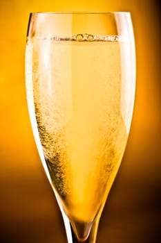 close up of champagne flute on golden background