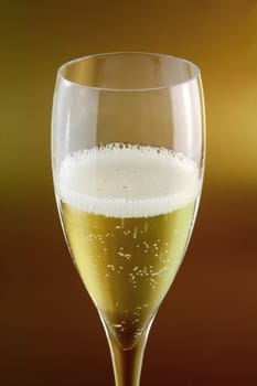 close up of champagne glass on golden background