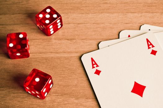 detail of red dice and cards on old wood