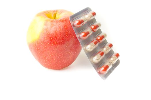 detail of pills blister and a apple