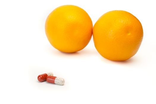 detail of pills and a orange