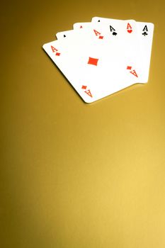 detail of  poker hand on gold background
