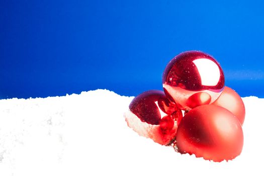 close up of a christmas decoration balls on blue background - empty space for text