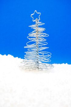 close up of a  christmas silver tree on blue background