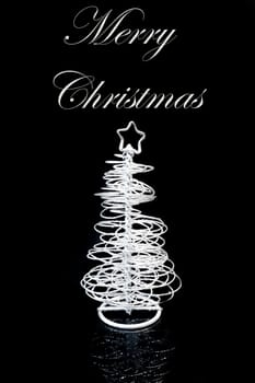 close up of a christmas silver tree on black background with space for text