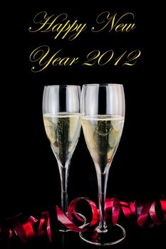 detail of glasses of champagne with red decoration on black background with space for text