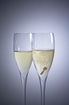 detail of glasses of champagne and a ring inside