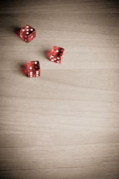 detail of red dice on old wood 