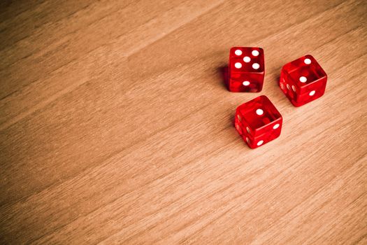 detail of red dice on old wood with space for text