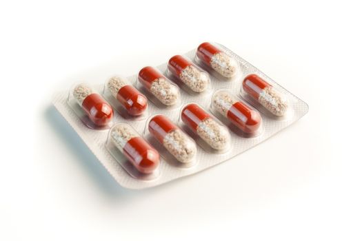 blister pack of red pills isolated on white background