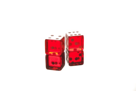 close up of a pair of dice on the white reflecting table