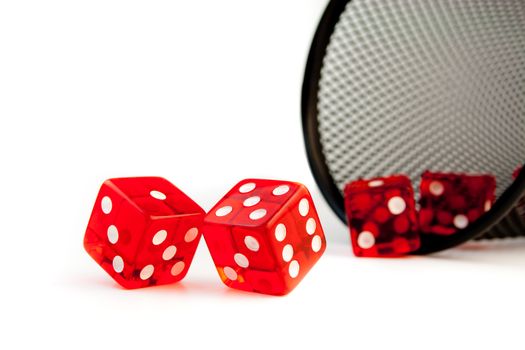 Close Up of five red dice near a container on white background