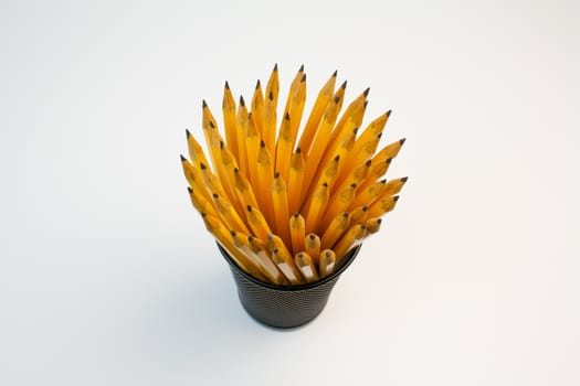 Detail view of a container filled with pencils taken in a office