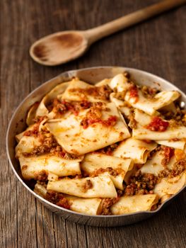 close up of rustic italian pasta in ragu sauce