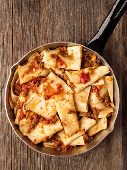 close up of rustic italian pasta in ragu sauce