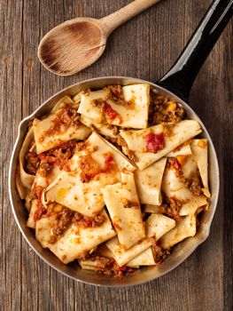 close up of rustic italian pasta in ragu sauce