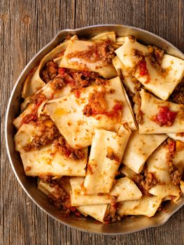 close up of rustic italian pasta in ragu sauce