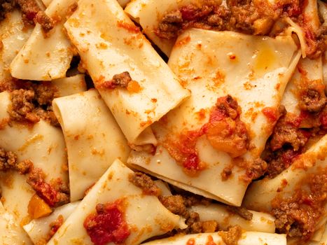 close up of rustic italian pasta in ragu sauce food background