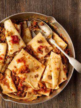 close up of rustic italian pasta in ragu sauce