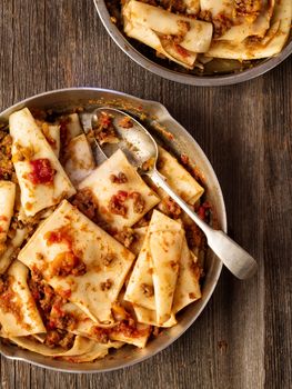 close up of rustic italian pasta in ragu sauce