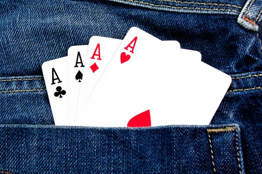 details of four poker cards in back pocket jeans