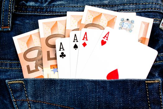 details of four 50 euro Banknotes and poker cards in back pocket jeans