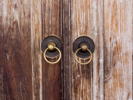 wooden door or gate and old vintage metal door ring handle knocker