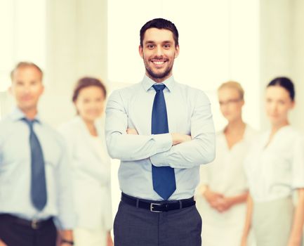 business and office concept - handsome businessman with crossed arms