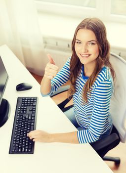 hone, technology and education concept - dreaming teenage girl with computer showing thumbs up at home