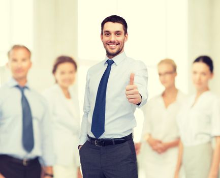 business and office concept - handsome businessman with crossed arms