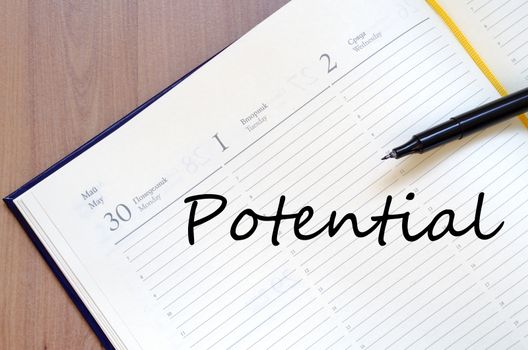 Notepad and pen on wooden background and text concept