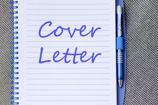 Notepad and pen on wooden background and text concept