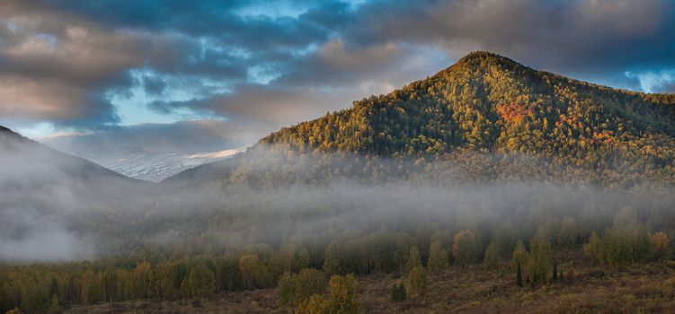 sunrise in autumn taiga and mountains