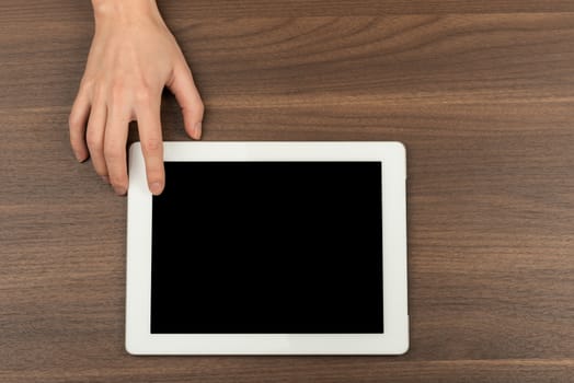 Humans using tablet on wooden table background
