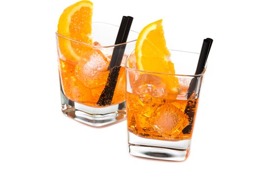 two glasses of spritz aperitif aperol cocktail with orange slices and ice cubes isolated on white background