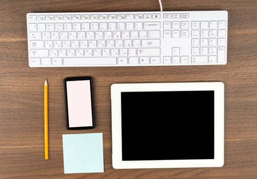 Smartphone with office supplies on wooden table