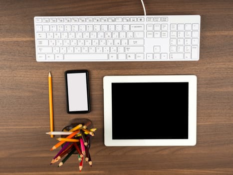 Smartphone with office supplies on wooden table