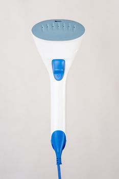 Image hand domestic garment steamer in phases, isolated on a light background