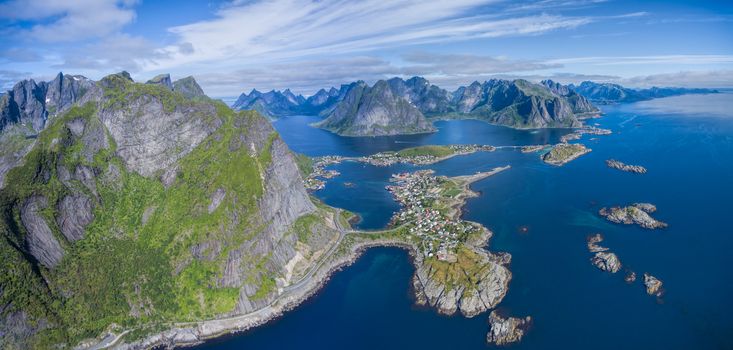 Reine on Lofoten surrounded by fjords and magnificent mountain peaks, aerail panorama