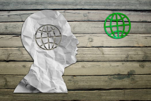 Paper humans head with globe symbol on wood deck background