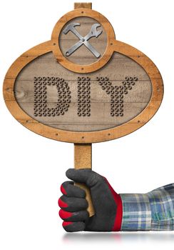 Hand with work glove holding a oval wooden sign with text Diy (Do it yourself) and a symbol with hammer and wrench. Isolated on white background