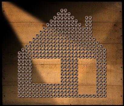 Many screws in the shape of house on a brown wooden background with nails. isolated on black background.