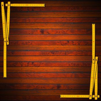 Frame made from a old wooden ruler on a dark wooden background with horizontal planks