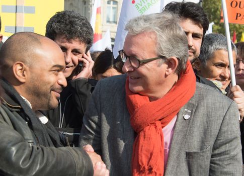 FRANCE, Paris : National head of Communist party Pierre Laurent (R) and SOS Racism head Dominique Sopo shake hands while protesters gather in Place de la R�publique in Paris on October 11, 2015, for the second time after the terror attack in Ankara, in tribute to the victims of the twin explosion in Turkish capital city. On October 11, 2015, at least 95 people died after a twin explosion in the center of the capital city in Turkey. The Turkish government declared three days of mourning and said that it won't delay legislative elections expected for November 1st, 2015. 