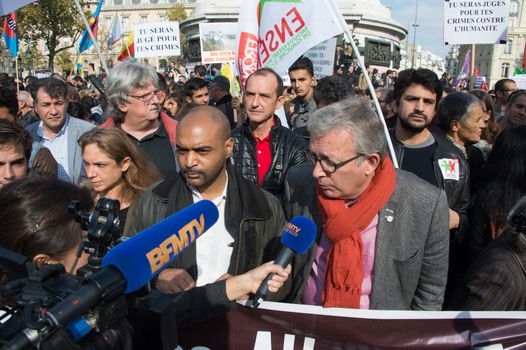 FRANCE, Paris : National head of Communist party Pierre Laurent (R) and SOS Racism head Dominique Sopo answer media questions while protesters gather in Place de la R�publique in Paris on October 11, 2015, for the second time after the terror attack in Ankara, in tribute to the victims of the twin explosion in Turkish capital city. On October 11, 2015, at least 95 people died after a twin explosion in the center of the capital city in Turkey. The Turkish government declared three days of mourning and said that it won't delay legislative elections expected for November 1st, 2015. 
