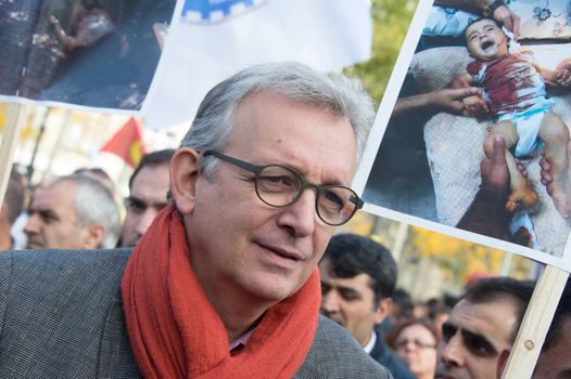 FRANCE, Paris : National head of Communist party Pierre Laurent stands while protesters gather in Place de la R�publique in Paris on October 11, 2015, for the second time after the terror attack in Ankara, in tribute to the victims of the twin explosion in Turkish capital city. On October 11, 2015, at least 95 people died after a twin explosion in the center of the capital city in Turkey. The Turkish government declared three days of mourning and said that it won't delay legislative elections expected for November 1st, 2015. 