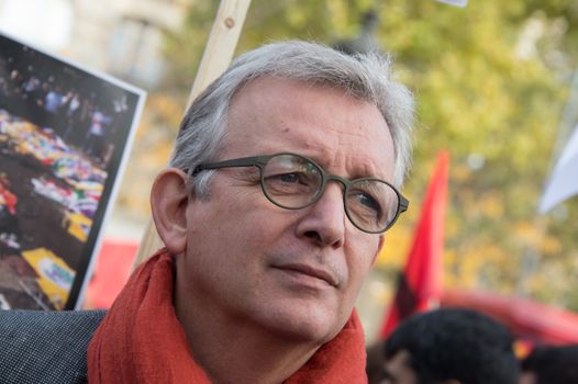 FRANCE, Paris : National head of Communist party Pierre Laurent stands while protesters gather in Place de la R�publique in Paris on October 11, 2015, for the second time after the terror attack in Ankara, in tribute to the victims of the twin explosion in Turkish capital city. On October 11, 2015, at least 95 people died after a twin explosion in the center of the capital city in Turkey. The Turkish government declared three days of mourning and said that it won't delay legislative elections expected for November 1st, 2015. 